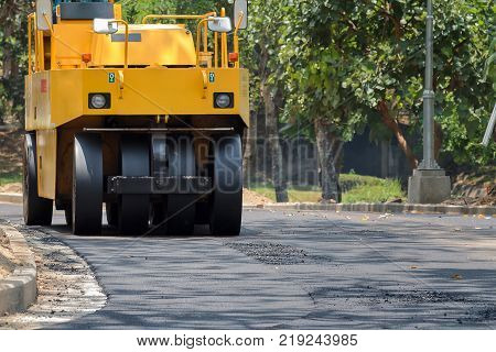 Worker Uses Vibratory Plate Compactor Compacting Asphalt At Road Repair