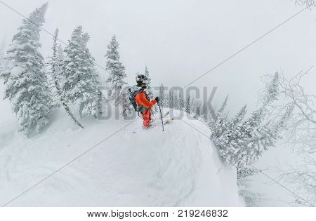 Man Skier Freerider Standing At Top Of Ridge, Adventure Winter Freeride Extreme Sport