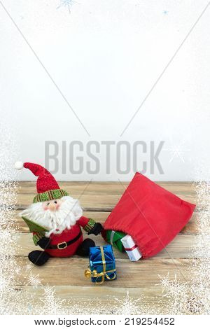 Christmas holidays composition on wooden background.. Santa claus carries gifts in a bag