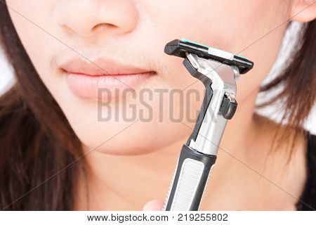 Closeup woman hand holding razor pre for shaving face health care and beauty concept selective focus