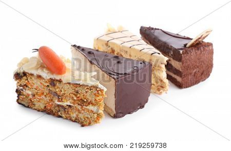 Pieces of tasty cakes on white background