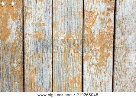old wooden wall with peeling brown paint