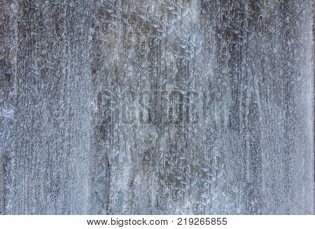 old wooden wall covered with frost from the cold