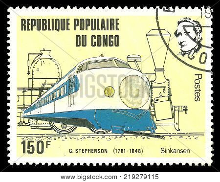 Kiev Ukraine December 22 2017: Stamp printed by Congo Color edition on topic of Railway devoted 200th birthday of George Stephenson shows train of blue and white color CIRCA 1982