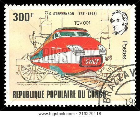 Kiev Ukraine December 22 2017: Stamp printed by Congo Color edition on topic of Railway devoted 200th birthday of George Stephenson shows train of red color CIRCA 1982