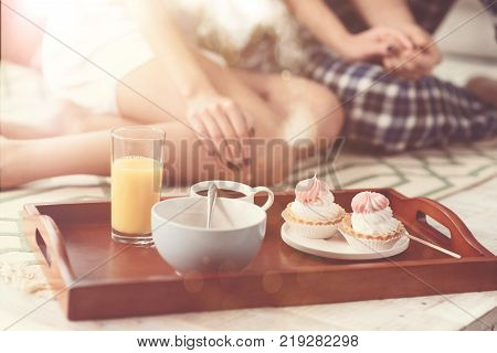 Romantic vibes. Two beautiful loving people having a great morning and eating they morning meal while spending the weekend at home together
