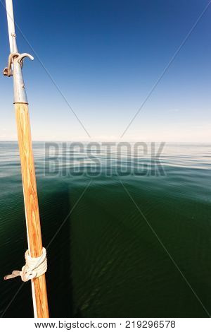 Boat hook on sailboat deck yacht outdoor shot on blue sky background.