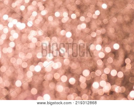 Bright and sparkling bokeh background. Rosegold bokeh -blurred lighting from glitter texture. background.