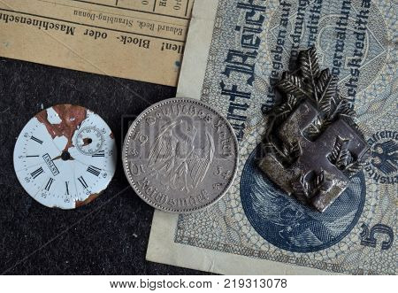 ILLUSTRATIVE EDITORIAL.Polish Army insignia (found with metal detector near Kiev).German vintage coin WWII time.  .Kiev,Ukraine December 21 ,2017