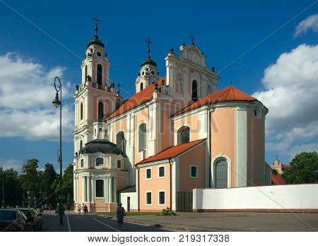 Vilnius Lithuania - August 16 2017: Church of St. Catherine (1650 by Johann Christoph Glaubitz) Vilniaus srtreet and passersby.