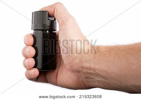 Hand with bottle of pepper spray in eyes, isolated on white background