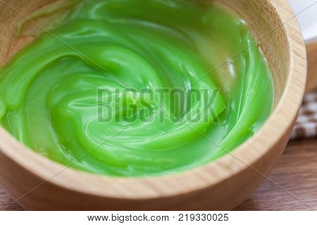 Pandan coconut custard dip on wooden plate
