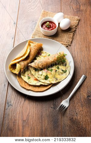 omelette / omelette chapati roll or Indian bread or roti rolled with omlet. Popular, quick and healthy recipe for kid's tiffin or lunch box