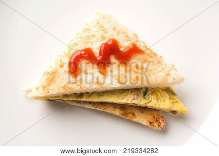 Indian Bread omelette / omlet / omlete sandwich served with tomato ketchup