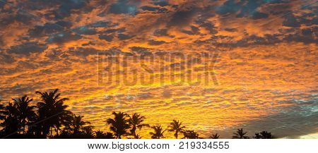Sunset At The Beach With Tourists Enjoying