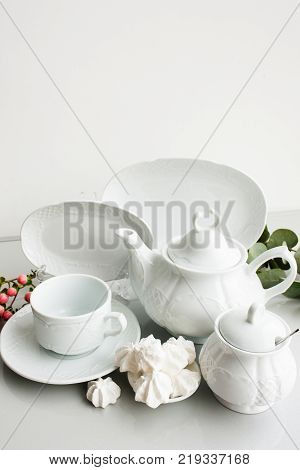 Expensive porcelain tea set on white background. Proper quality dishes concept