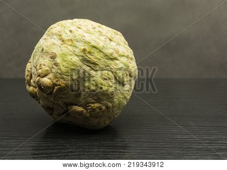 Fresh celery root on a wooden table.