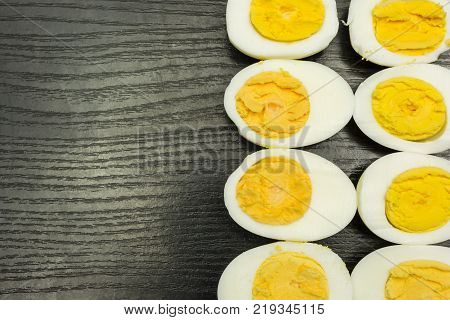 Boiled hard-boiled eggs on a wooden table.