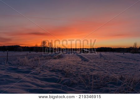 Sunset over a snowy and cold varmland in Sweden