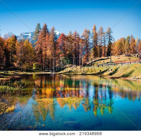 Fantastic colors view of Scin lake with yellow larch trees. Colorful sunny scene in Dolomite Alps Cortina d'Ampezzo location Italy Europe. Artistic style post processed photo.