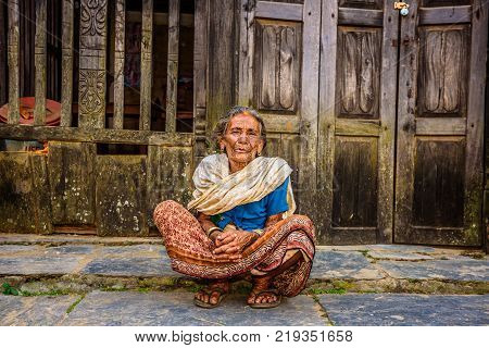 BANDIPUR, NEPAL - OCTOBER 22, 2015 :  Old woman begs in the street of Bandipur