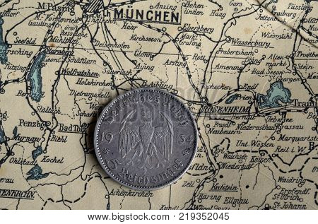 ILLUSTRATIVE EDITORIAL.German vintage coin.Background - German vintage map of Central Europe circa 1944 fragment.
Kiev,Ukraine December 22 ,2017