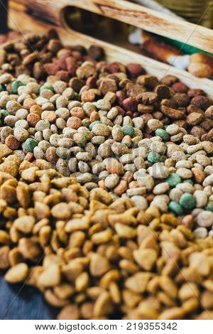 Dry pet food for dogs and cats on table.