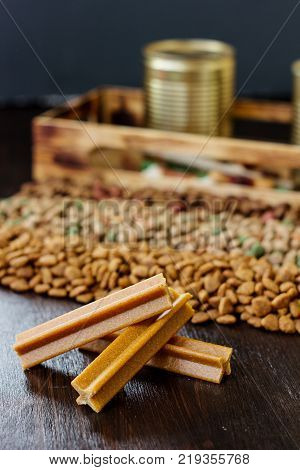 Dry pet food on black wooden table