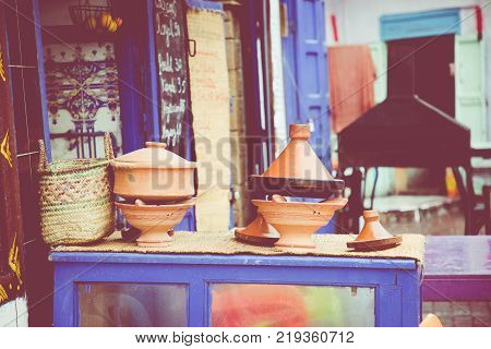 Cooking traditional Moroccan dish meat and vegetable in ceramic tajine in Marrakech in Morocco.