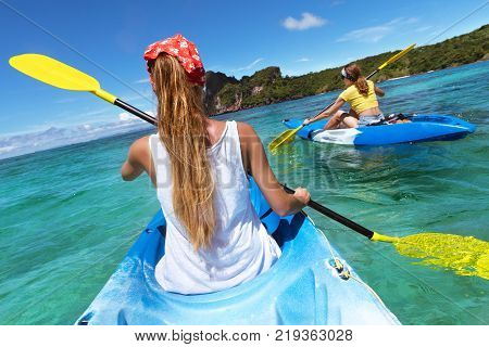 Two ladies kayaking or kanoeing at Phi-Phi Don lagoon. Krabi province, Thailand.