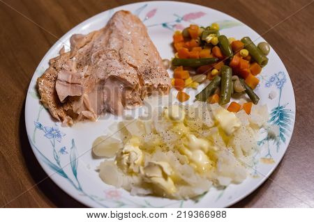 Salmon dinner night with potatoes and mixed vegtables plate