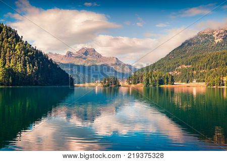 Sunny summer landscape of Silvaplana lake. Colorful morning view of Segl village Maloja pass Upper Engadine in the Swiss canton of the Grisons Switzerland Europe. Artistic style post processed photo.