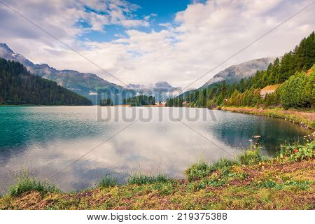 Sunny summer landscape of Silvaplana lake. Colorful morning view of Segl village Maloja pass Upper Engadine in the Swiss canton of the Grisons Switzerland Europe. Artistic style post processed photo.