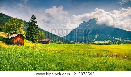 Green meadow on the Golf club Zugspitze Lermoos village loccation. Colorful summer panorama of Austrian Alps Reutte district state of Tyrol Austria Europe. Artistic style post processed photo.