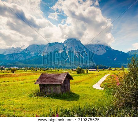 Green meadow on the Golf club Zugspitze Lermoos village loccation. Colorful summer morning in Austrian Alps Reutte district state of Tyrol Austria Europe. Artistic style post processed photo.