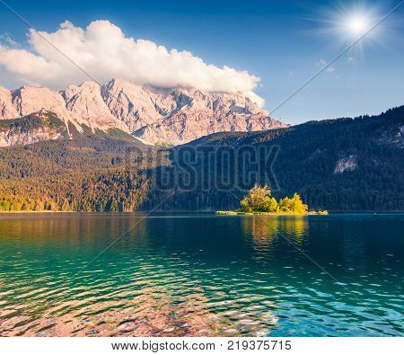 Sunny summer morning on the Eibsee lake with Zugspitze mountain range. Splendid outdoor scene in German Alps Bavaria Garmisch-Partenkirchen village location Germany Europe.
