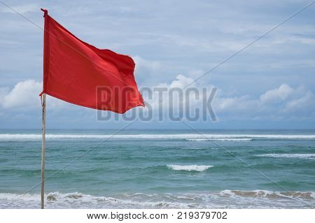 A red warning flag on the beach in the Nuca Dua Bali, Indonesia. Danger to swim in ocean