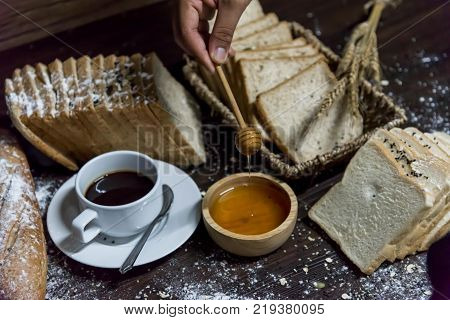 Fresh Tasty Bread With Coffee,sesame, Cereal And Honey Bee On The Table.