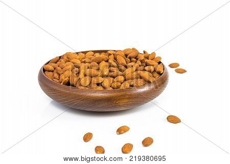 Almond in a wooden bowl with classic cloth on a white background. clipping path