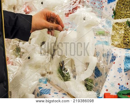 The girl's hand chooses presents at the Christmas Market