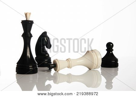 Chess game isolated on white background. Chess king is checkmated, chess game over. Black and white chess pieces business concept, leader success.