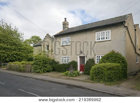 Street view of an old cottage in the pretty village of Foxton Cambridgeshire England UK