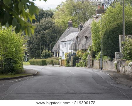 Street view of old thatched cottages in the pretty village of Foxton Cambridgeshire England UK