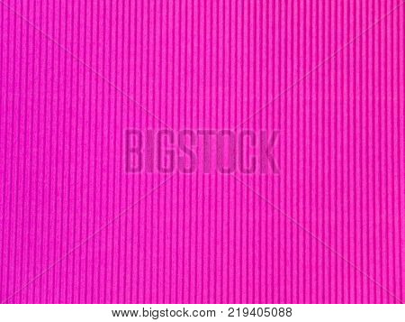 Bright purple vertical corrugated paper texture closeup.