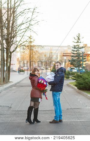 Happy Father Meets His Wife With A Newborn Baby