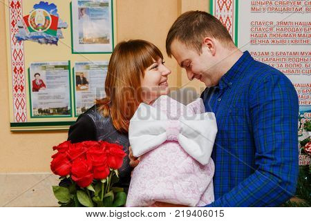Happy Father Meets His Wife With A Newborn Baby