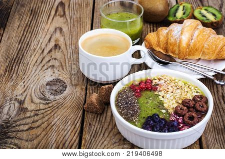Espresso, croissant and fruit dessert for breakfast. Studio Photo