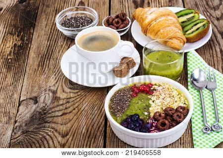 Espresso, croissant and fruit dessert for breakfast. Studio Photo