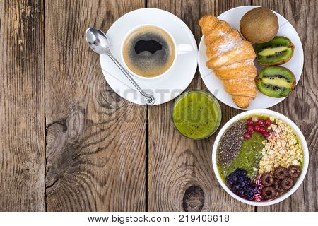 Espresso, croissant and fruit dessert for breakfast. Studio Photo