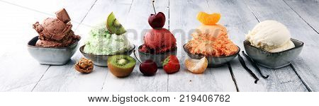Set of ice cream scoops of different colors and flavours with berries nuts and fruits